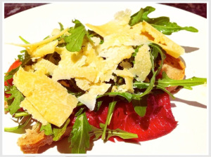 bresaola served on bread with parmesan and cheese 